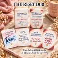 The Reset Duo: Original Reset and Blunt Reset boxes with two cards from each deck in a blush and cream setting